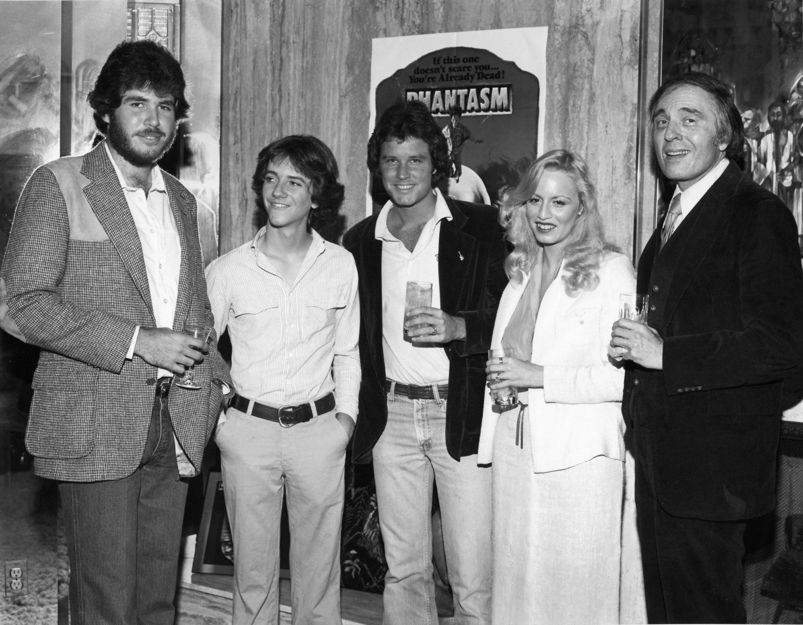 The cast and crew of "Phantasm" toast its success. From left to right: Don Coscarelli, Michael Baldwin, Bill Thornbury, Kathy Lester and Angus Scrimm. (Courtesy Silver Sphere Productions)